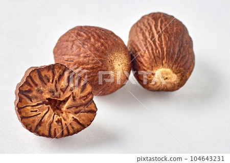 three nutmegs on a white background with copy three nutmegs on a white background with copy 104643231
