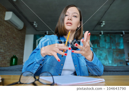 Close-up webcam view of face female university student Close-up webcam view of face female university student 104643790