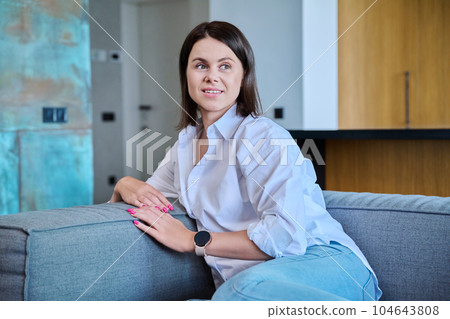 Portrait of attractive young woman in modern home interior 104643808