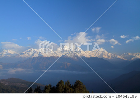 Nepal in South Asia View of the Dhaulagiri Mountains at dawn from Poon Hill Observation Deck, a famous spot for viewing the Himalayas 104645199
