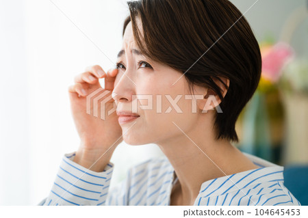 A young woman scratching her eyes Hay fever image A young woman scratching her eyes Hay fever image 104645453