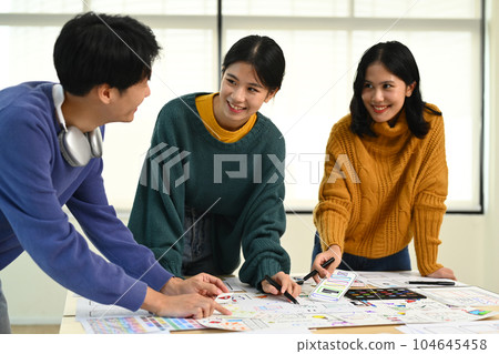Image of mobile application designers team discussing, brainstorming for new approaches and ideas together Image of mobile application designers team discussing, brainstorming for new approaches and ideas together 104645458