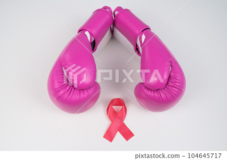 Pink boxing gloves and pink ribbon on a white background. The concept of the fight against breast cancer.  104645717
