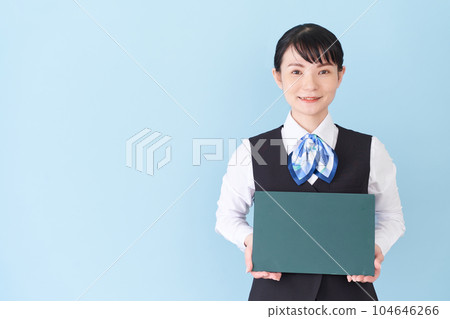 A woman in reception work and clerical work wearing a uniform with a ribbon tie on a vest with a blackboard A woman in reception work and clerical work wearing a uniform with a ribbon tie on a vest with a blackboard 104646266