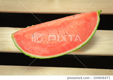 The watermelon placed on a wooden board. The watermelon placed on a wooden board. 104646471