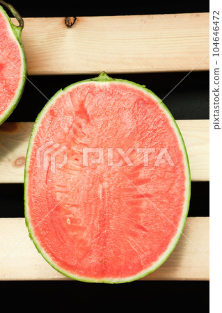 The watermelon placed on a wooden board. The watermelon placed on a wooden board. 104646472
