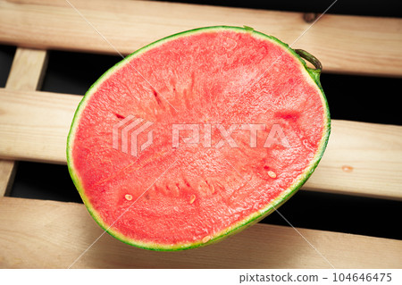The watermelon placed on a wooden board. The watermelon placed on a wooden board. 104646475