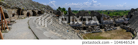 Side Ancient theatre. Turkey. Antalya. Ruins of the ancient city of Side. The largest amphitheater in Turkey. Main street of the ancient city. Mediterranean Sea. Side Ancient theatre. Turkey. Antalya. Ruins of the ancient city of Side. The largest amphitheater in Turkey. Main street of the ancient city. Mediterranean Sea. 104646524