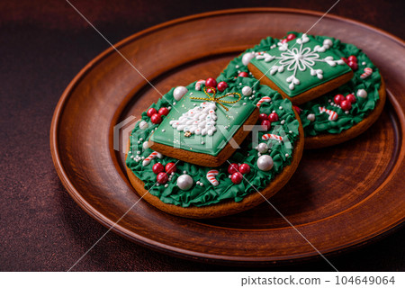 Beautiful delicious Christmas gingerbread on a concrete texture background Beautiful delicious Christmas gingerbread on a concrete texture background 104649064