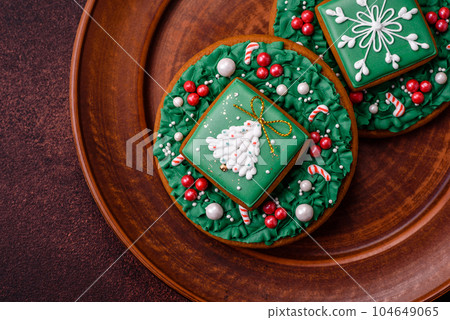 Beautiful delicious Christmas gingerbread on a concrete texture background Beautiful delicious Christmas gingerbread on a concrete texture background 104649065