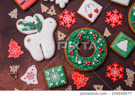 Beautiful delicious Christmas gingerbread on a concrete texture background Beautiful delicious Christmas gingerbread on a concrete texture background 104649077