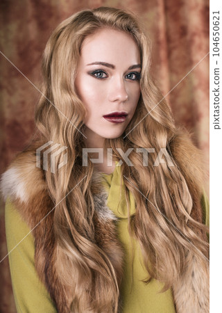 glamorous portrait of a beautiful young woman in a fur vest close up of fashion retouched shot 104650621