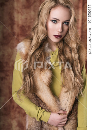 glamorous portrait of a beautiful young woman in a fur vest close up of fashion retouched shot 104650625