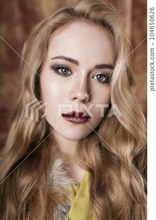 glamorous portrait of a beautiful young woman in a fur vest close up of fashion retouched shot glamorous portrait of a beautiful young woman in a fur vest close up of fashion retouched shot 104650626