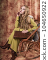 glamorous portrait of a beautiful young woman in a fur vest holding a bag 104650922