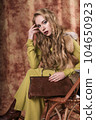 glamorous portrait of a beautiful young woman in a fur vest holding a bag 104650923