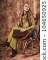 glamorous portrait of a beautiful young woman in a fur vest holding a bag 104650925