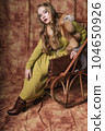 glamorous portrait of a beautiful young woman in a fur vest holding a bag 104650926