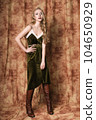 Beautiful fashion model in a velvet green dress. Vintage. Luxury style. 104650929