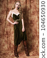 Beautiful fashion model in a velvet green dress. Vintage. Luxury style. 104650930