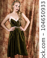 Beautiful fashion model in a velvet green dress. Vintage. Luxury style. 104650933