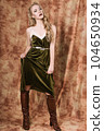 Beautiful fashion model in a velvet green dress. Vintage. Luxury style. 104650934