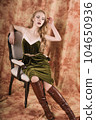 Beautiful fashion model in a velvet green dress. Vintage. Luxury style. 104650936