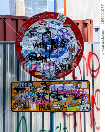 A road sign completely painted with graffiti 104651077