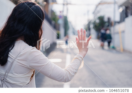 A mother picking up a child outside 104651078