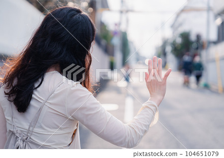 A mother picking up a child outside A mother picking up a child outside 104651079