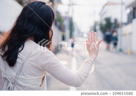 A mother picking up a child outside 104651080