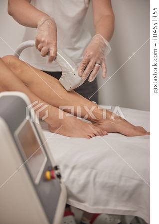 Smooth skin, Removing hair, SPA concept. Concept of cosmetology, laser epilation discuss today, long section of woman getting laser treatment on leg at spa, epilation and cosmetology Smooth skin, Removing hair, SPA concept. Concept of cosmetology, laser epilation discuss today, long section of woman getting laser treatment on leg at spa, epilation and cosmetology 104651155