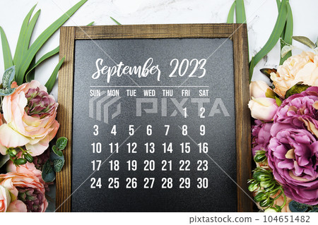 September 2023 monthly calendar with flower bouquet decoration on marble background 104651482