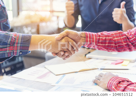 Team Business Partners shaking hands together to Greeting Start up small business in meeting room. Shakehand teamwork partners at modern office handshake together. Business mergers and acquisitions Team Business Partners shaking hands together to Greeting Start up small business in meeting room. Shakehand teamwork partners at modern office handshake together. Business mergers and acquisitions 104651512