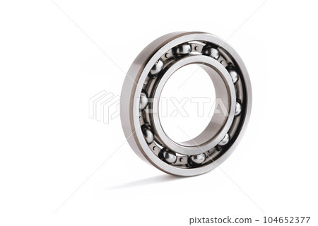 ball bearing on a white background close-up, blur as an artistic device, place for copy space ball bearing on a white background close-up, blur as an artistic device, place for copy space 104652377