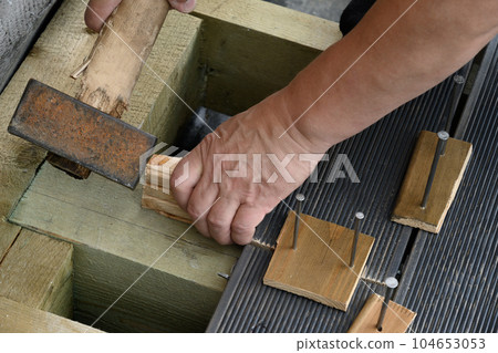 Construction and assembly of larch floor. Outdoors. Construction and assembly of larch floor. Outdoors. 104653053