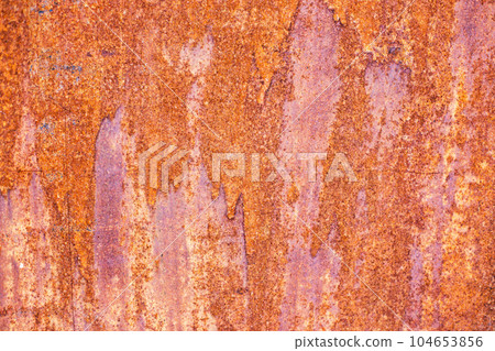 Orande rusty abstract painted metal background. texture of old plate with brown rust 104653856