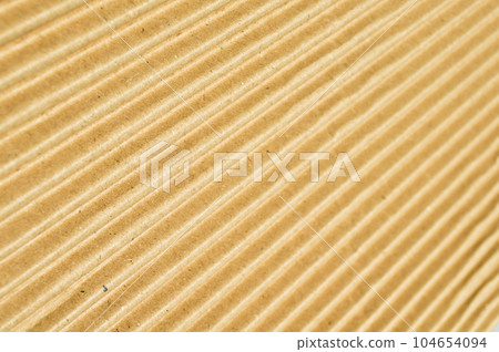 Brown and beige colored corrugated cardboard detail Brown and beige colored corrugated cardboard detail 104654094