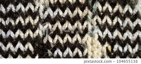 Handmade knitted fabric white brown wool background texture Handmade knitted fabric white brown wool background texture 104655138