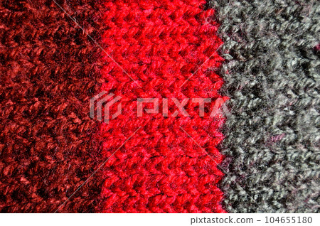 Handmade knitted fabric red and gray wool background texture Handmade knitted fabric red and gray wool background texture 104655180