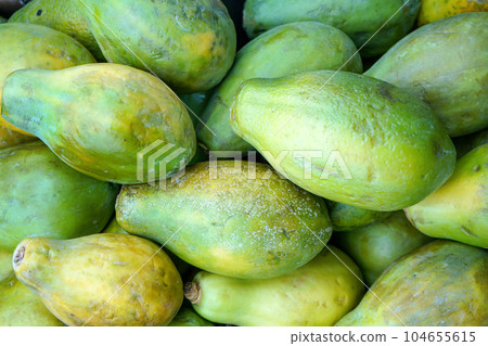 Green papaya fruits displayed on food market Green papaya fruits displayed on food market 104655615