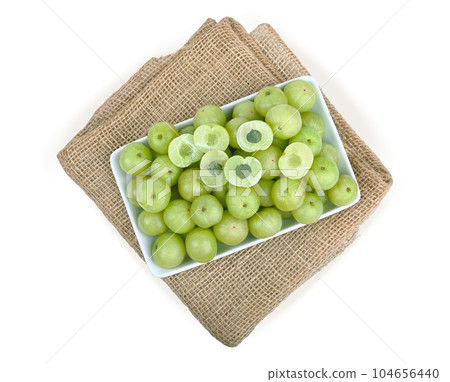 indian gooseberry in   white plate on sackcloth  white back ground. 104656440