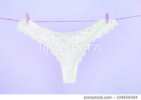 White sexy lace panties hanging on clothesline White sexy lace panties hanging on clothesline 104656484