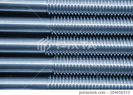 Closeup scene the spare parts lead ball screw parts in the light blue scene. Closeup scene the spare parts lead ball screw parts in the light blue scene. 104656553