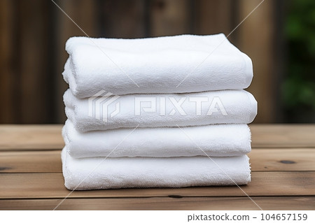 A set of white towels on the shelf A set of white towels on the shelf 104657159