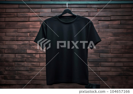Black cotton T-shirt hanging on a hanger, a place for text Black cotton T-shirt hanging on a hanger, a place for text 104657166