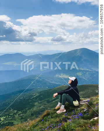 Woman on the top of a mountain Woman on the top of a mountain 104657956