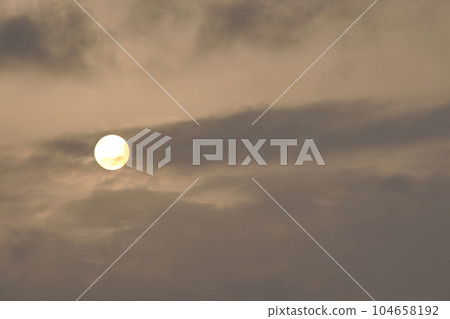 A sky, with diffused sun, clouds, colourful, 104658192