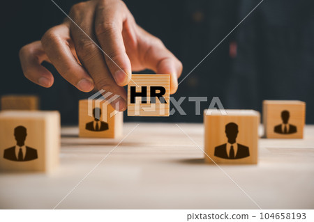 Hand selecting red human icon on wood block. Business hiring and recruitment. Career opportunity. HR Management. Leadership making crucial choices. Building a winning team. Human resource management Hand selecting red human icon on wood block. Business hiring and recruitment. Career opportunity. HR Management. Leadership making crucial choices. Building a winning team. Human resource management 104658193