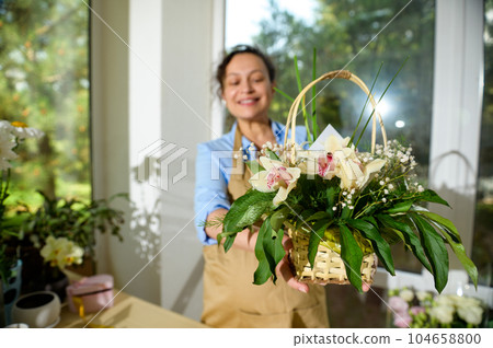 Beautiful bouquet of orchid flowers arranged in wicker basket Beautiful bouquet of orchid flowers arranged in wicker basket 104658800